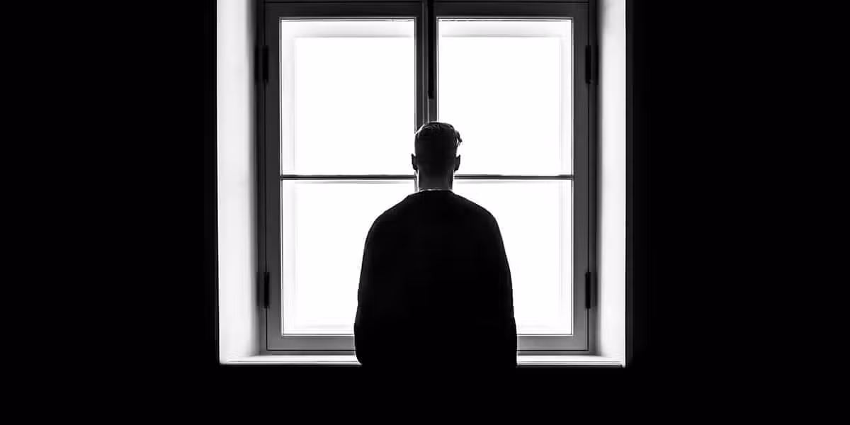 Man looks out a window