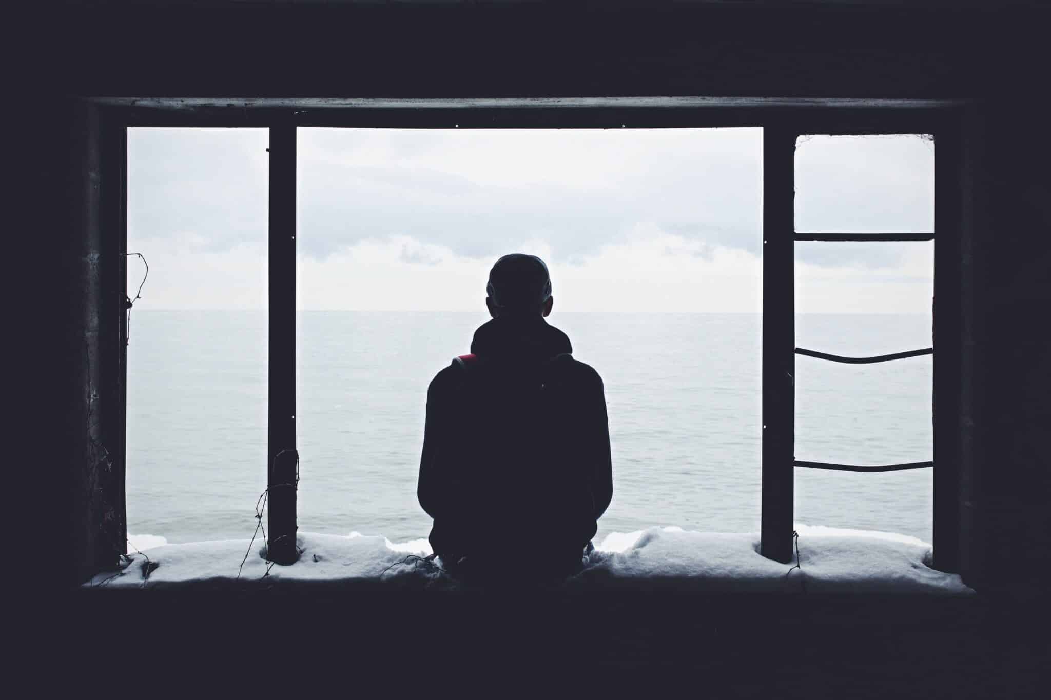man looking out a window | Photo by Noah Silliman on Unsplash